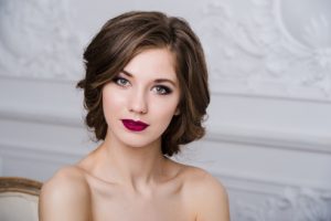 Portrait of beautiful woman with red lips at luxury interior room.